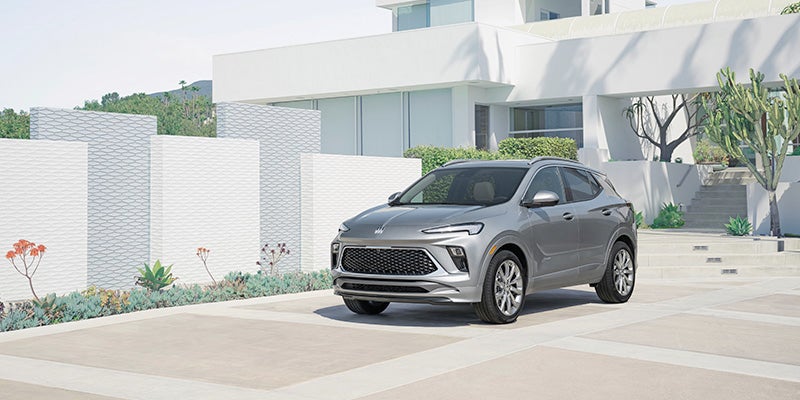 silver 2024 buick encore gx in front of a house