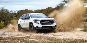 white 2024 gmc terrain driving in mud