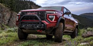 red 2025 gmc canyon in a field 
